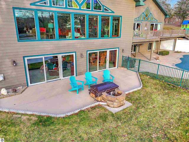 rear view of house with a lawn and a patio area