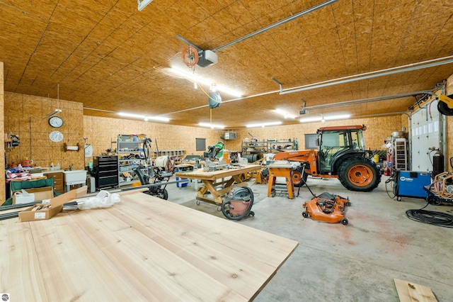 garage with a workshop area and a garage door opener