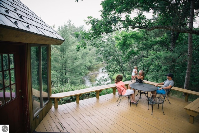 wooden deck featuring a water view