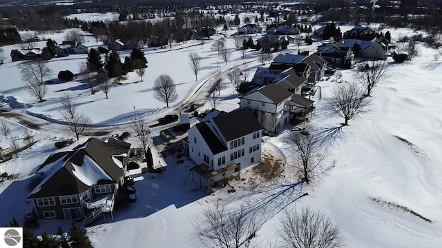 snowy aerial view with a residential view