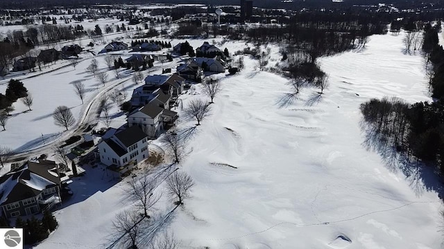 snowy aerial view with a residential view