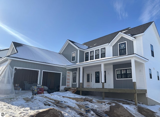 modern inspired farmhouse featuring a garage, covered porch, and board and batten siding