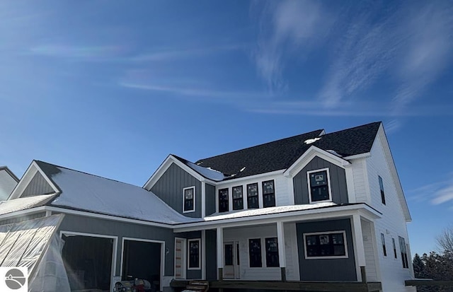 modern farmhouse style home featuring a porch, an attached garage, and board and batten siding