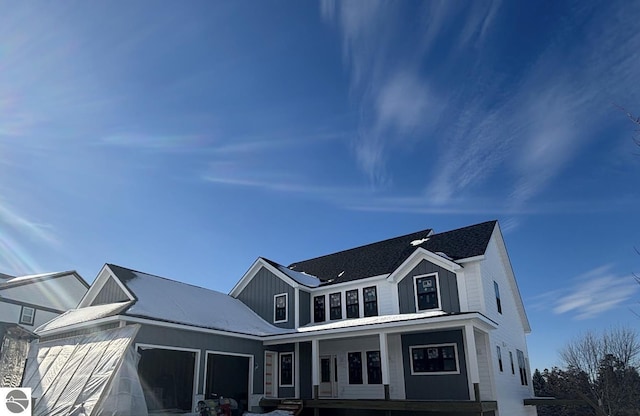 view of front of home with a garage, covered porch, and board and batten siding