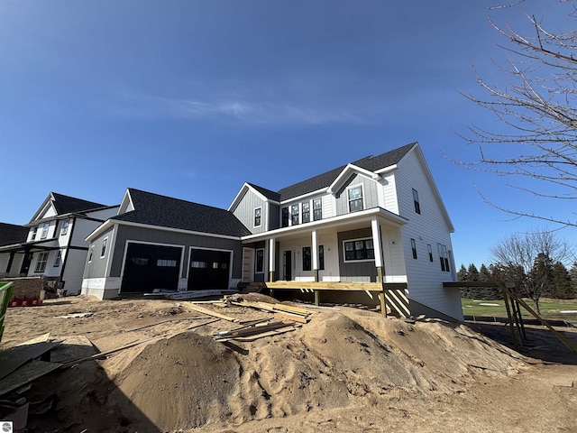 4325 Wolverine Dr, Williamsburg, MI 49690 - property in mid-construction featuring a garage and a porch