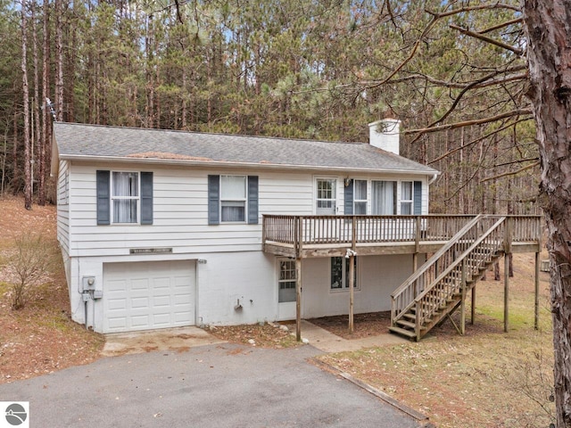 view of front property with a deck and a garage