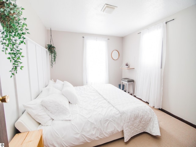 bedroom with light carpet