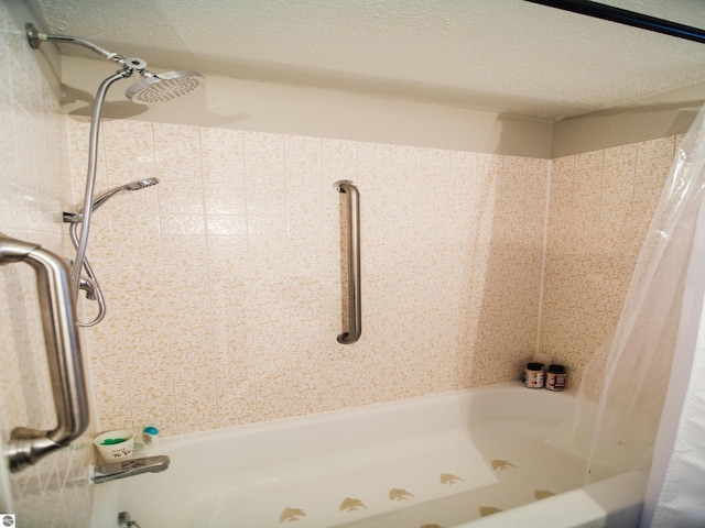 bathroom with shower / bath combination with curtain and a textured ceiling