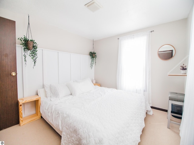 bedroom featuring light colored carpet