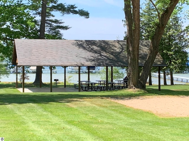 view of community featuring a water view and a lawn