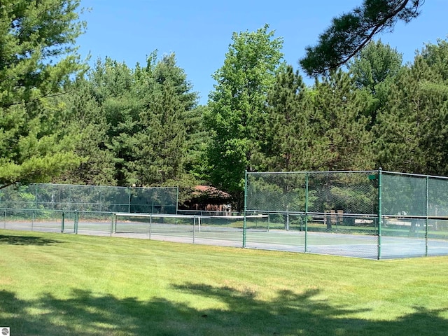 view of sport court featuring a yard