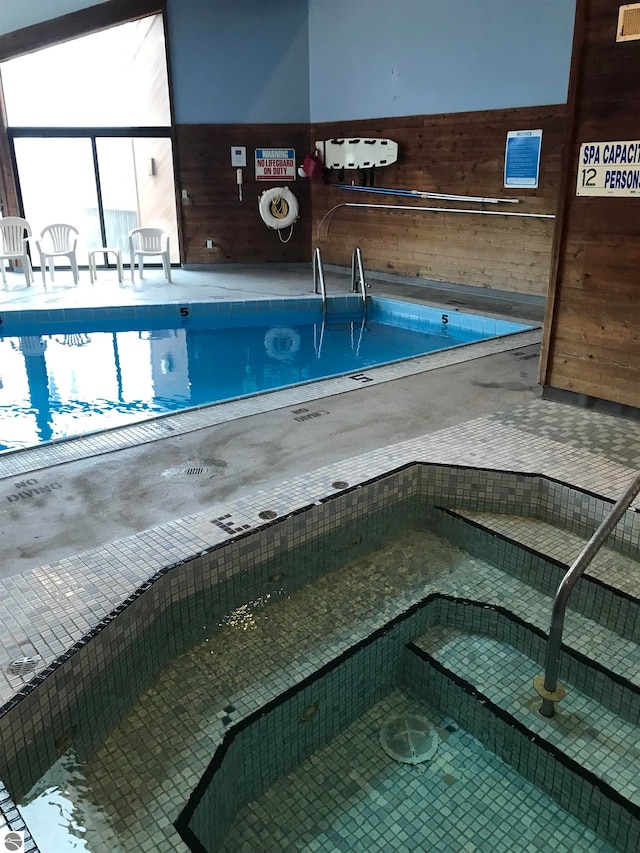 view of pool with an indoor hot tub