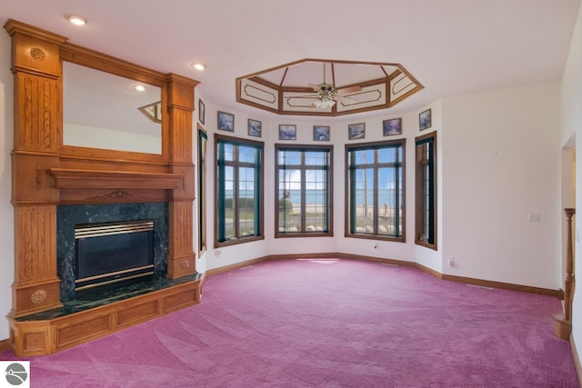 unfurnished living room with light carpet, ceiling fan, and a high end fireplace