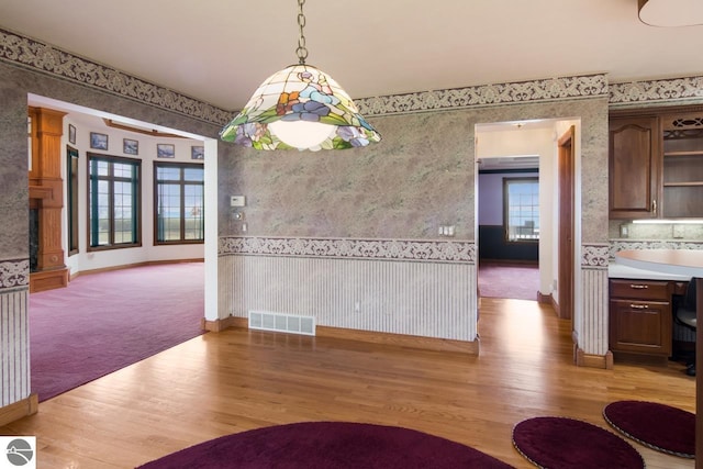 unfurnished dining area featuring light hardwood / wood-style floors