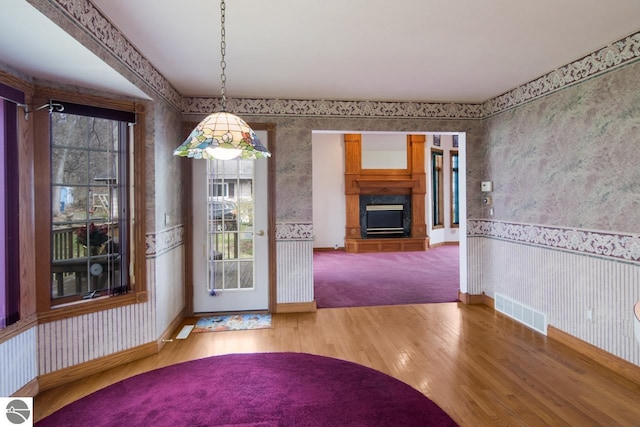 unfurnished dining area featuring light colored carpet