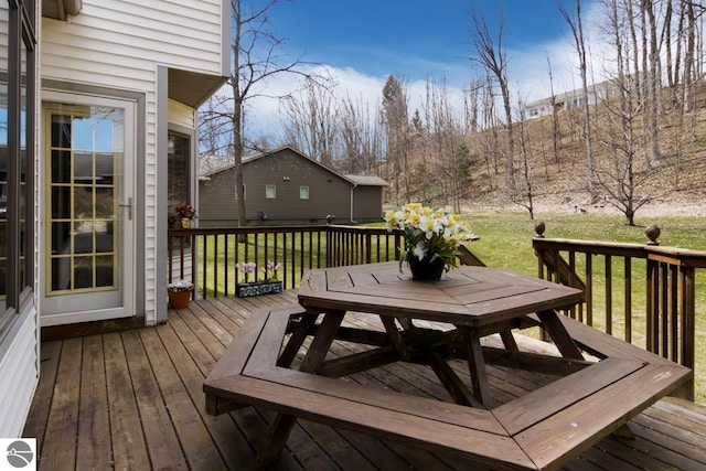 wooden terrace featuring a yard