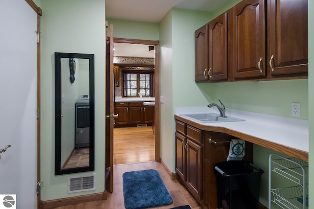 bathroom with hardwood / wood-style floors and sink