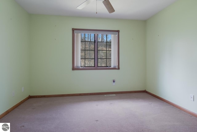 empty room featuring light carpet and ceiling fan