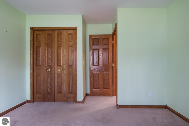 unfurnished bedroom featuring light colored carpet