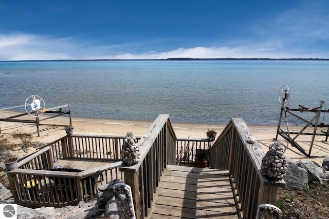 surrounding community featuring a view of the beach and a water view