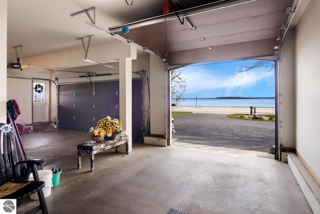 garage featuring a water view and a garage door opener