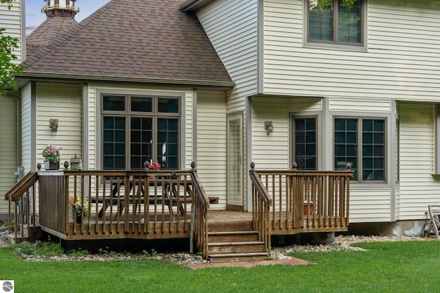 wooden terrace featuring a lawn