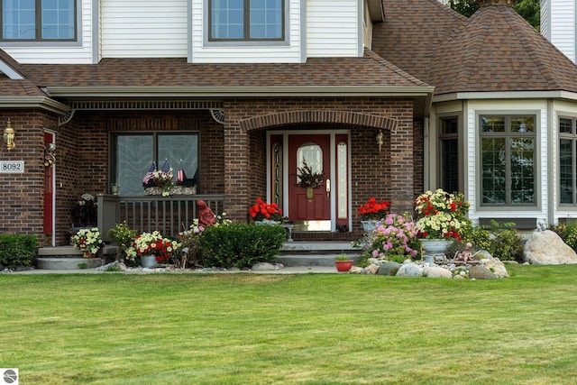 doorway to property featuring a lawn