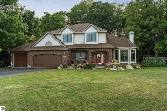 view of front of house with a front yard and a garage