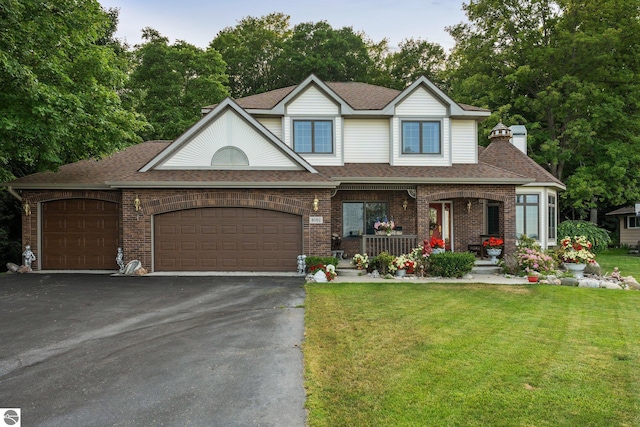 view of front of home with a garage and a front lawn