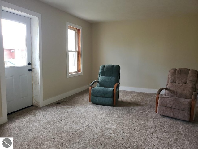 sitting room featuring a healthy amount of sunlight and carpet flooring