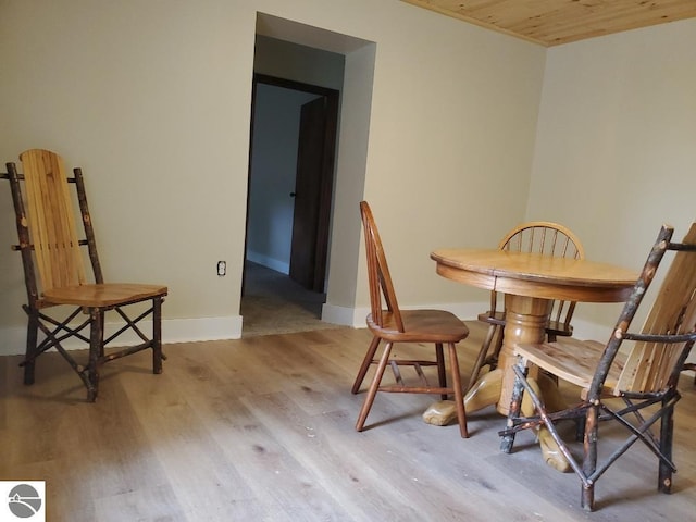 dining area with wooden ceiling and hardwood / wood-style floors