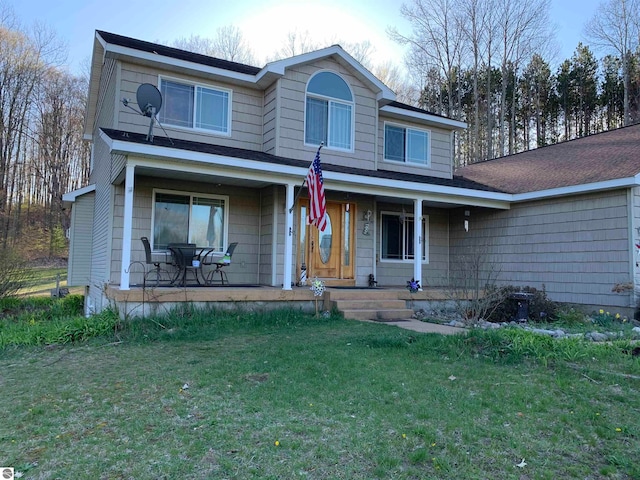 view of front of property featuring a front lawn and a porch