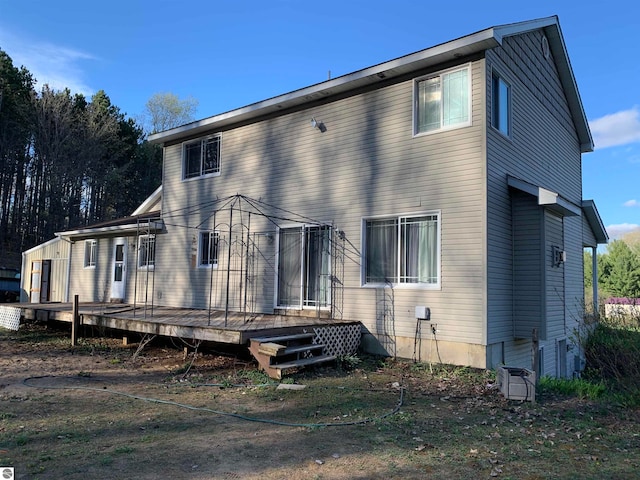 rear view of property featuring a deck