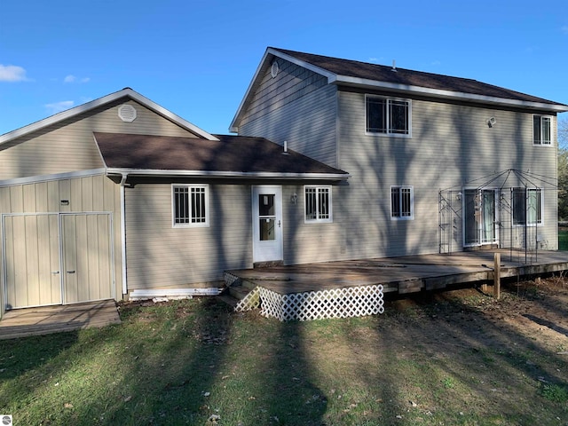 back of house featuring a deck and a yard