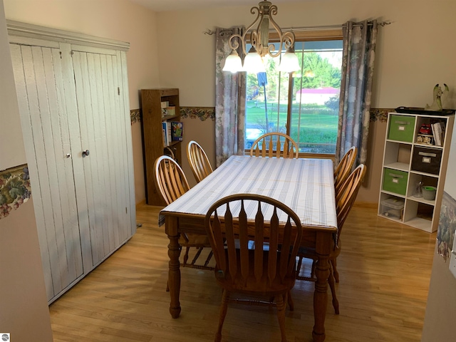 dining room with a notable chandelier and light hardwood / wood-style floors