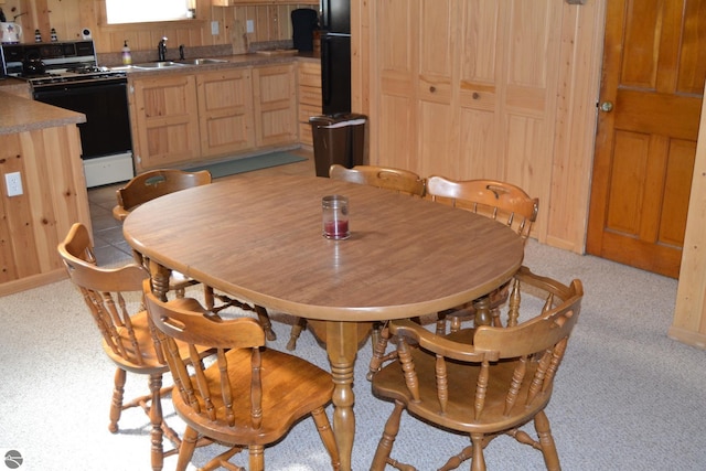 dining area with light colored carpet and sink