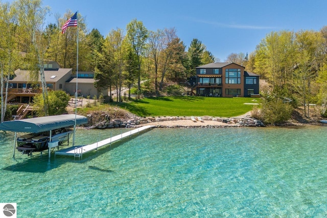 view of pool with a lawn and a boat dock