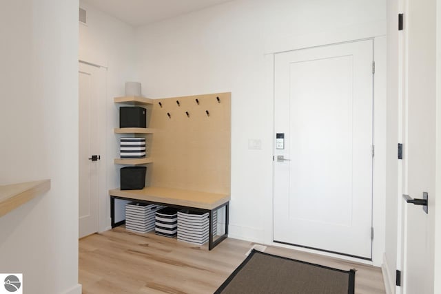 mudroom with light hardwood / wood-style floors