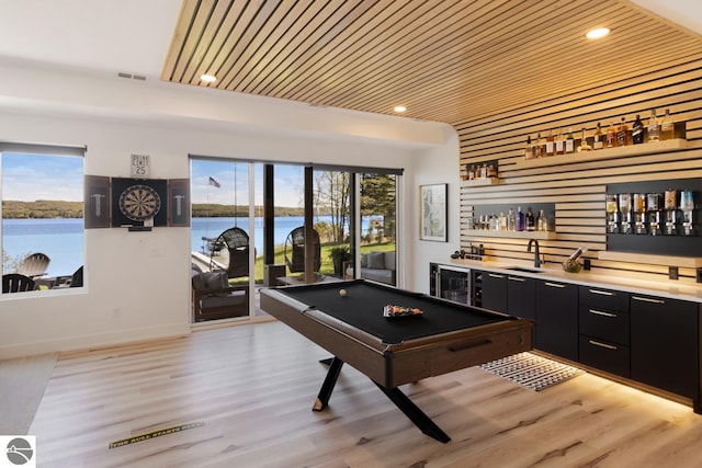 playroom featuring wood ceiling, light hardwood / wood-style floors, billiards, and a water view