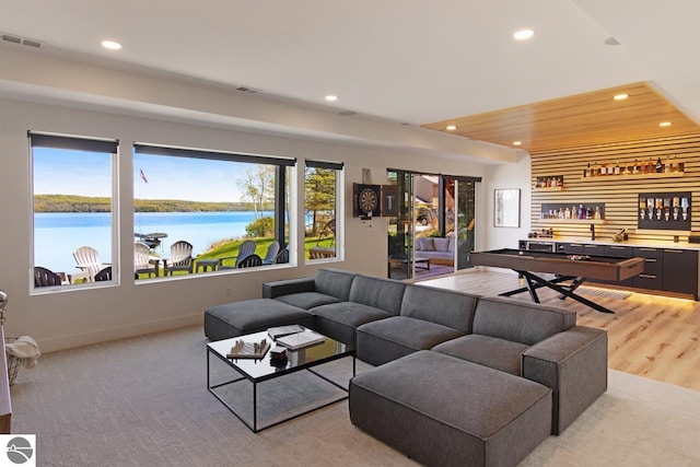 living room with light colored carpet and a water view