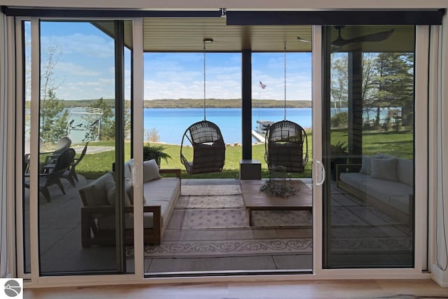 entryway with a water view, hardwood / wood-style floors, and a wealth of natural light