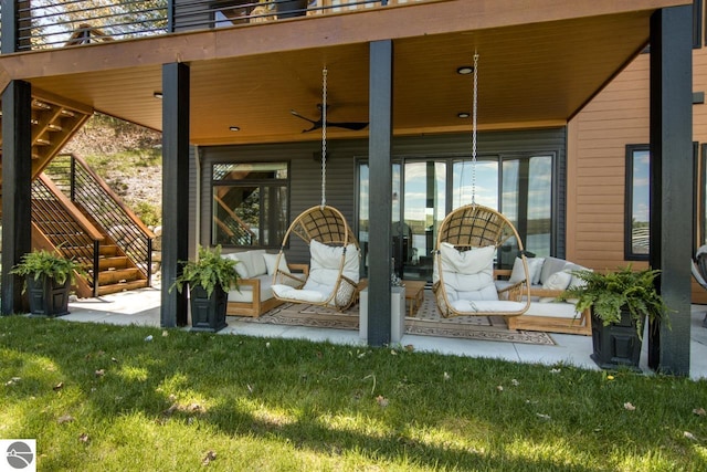 view of exterior entry with an outdoor living space, a yard, and ceiling fan