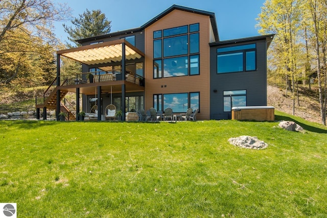 rear view of property featuring a deck and a lawn