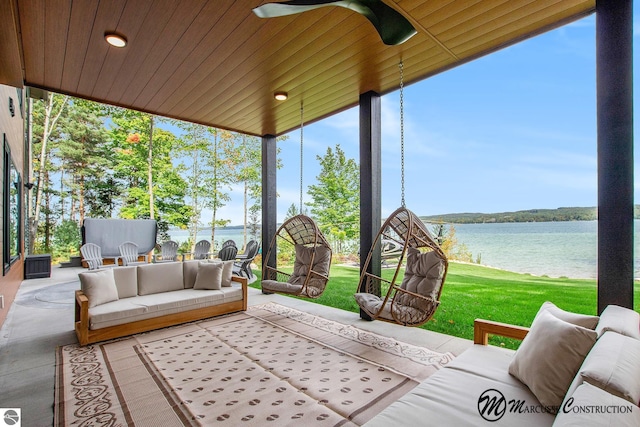 sunroom / solarium featuring ceiling fan, wooden ceiling, and a water view