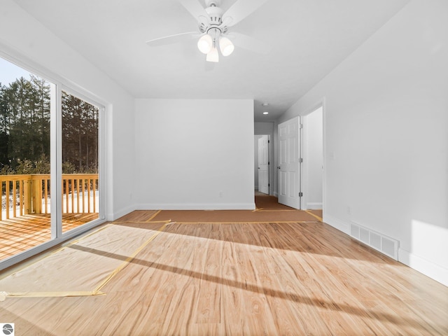 unfurnished room with ceiling fan and light wood-type flooring