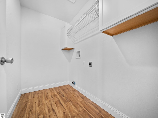 washroom featuring washer hookup, light hardwood / wood-style floors, electric dryer hookup, and cabinets