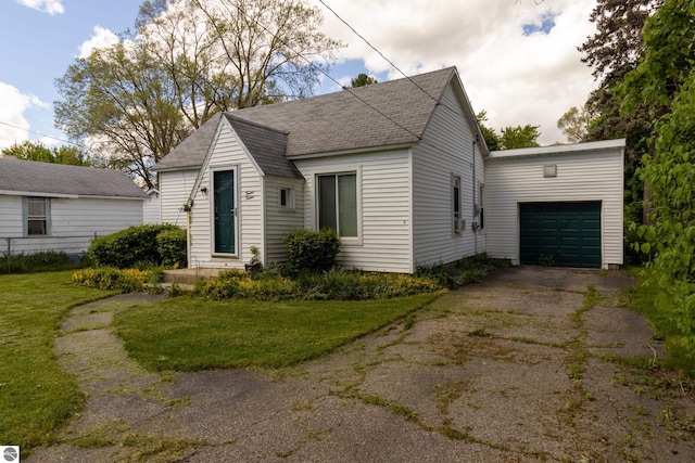 view of front of property with a garage and a front yard