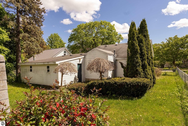 view of side of home with a lawn