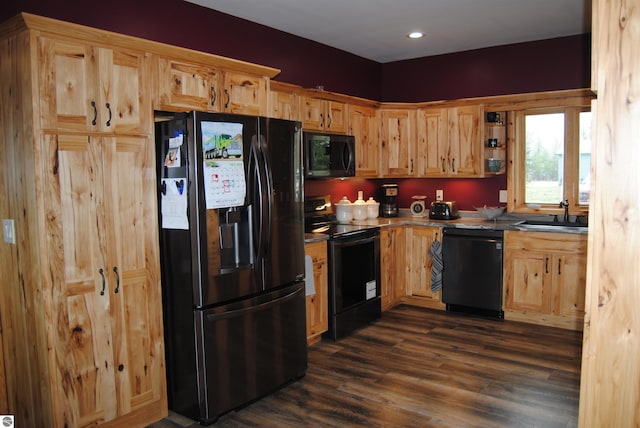 kitchen featuring sink, black appliances, and dark wood-type flooring