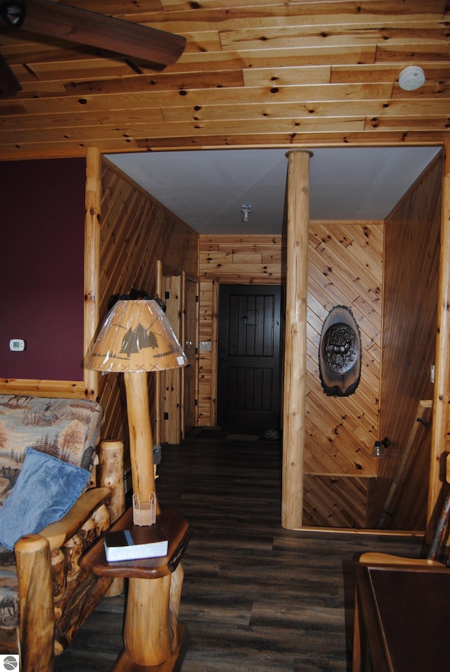 interior space featuring wooden walls and dark hardwood / wood-style floors